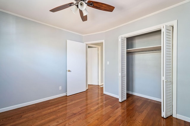 unfurnished bedroom featuring ceiling fan, ornamental molding, a closet, and hardwood / wood-style floors