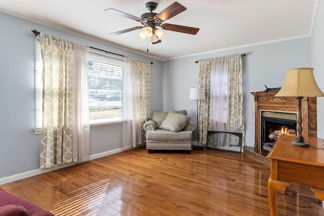 sitting room with ceiling fan, hardwood / wood-style floors, and ornamental molding