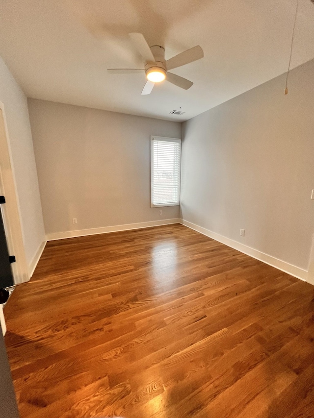 empty room with ceiling fan and hardwood / wood-style floors