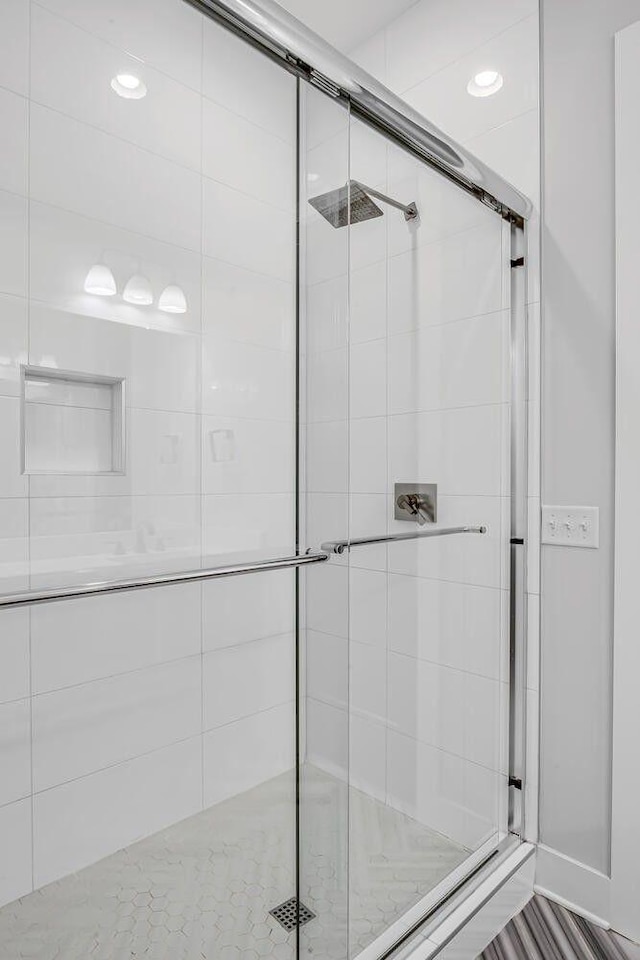 bathroom featuring a shower with shower door