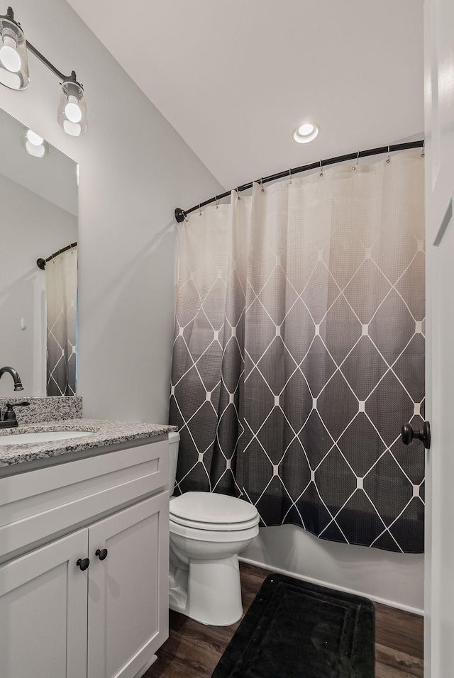 bathroom featuring hardwood / wood-style floors, toilet, vanity, and a shower with curtain