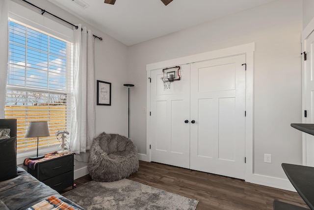 bedroom featuring ceiling fan, a closet, and dark hardwood / wood-style floors