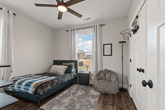 bedroom with ceiling fan and dark wood-type flooring