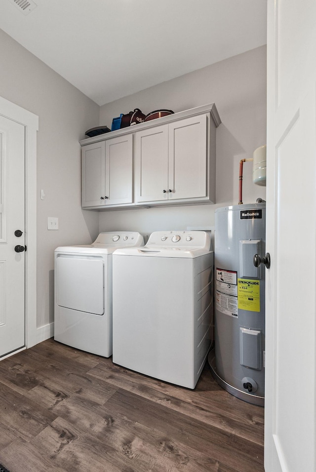 washroom featuring water heater, cabinets, dark hardwood / wood-style flooring, and independent washer and dryer