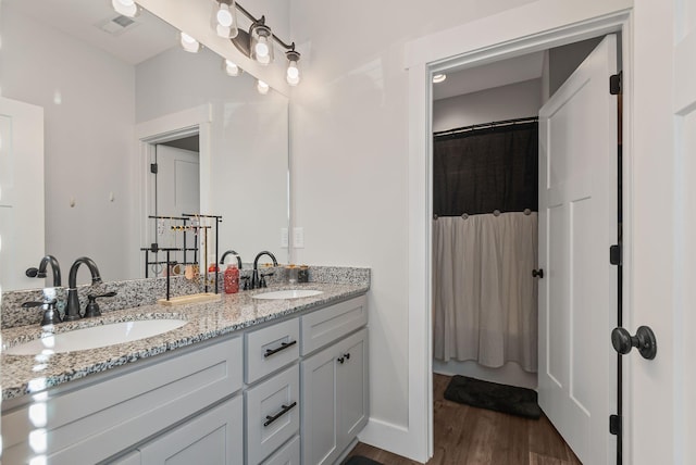 bathroom featuring vanity, curtained shower, and hardwood / wood-style floors