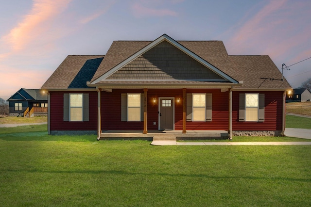 view of front facade with a yard and covered porch