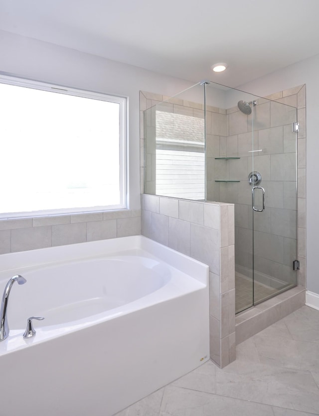 bathroom featuring shower with separate bathtub