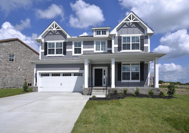 craftsman inspired home featuring a front lawn, a garage, and a porch