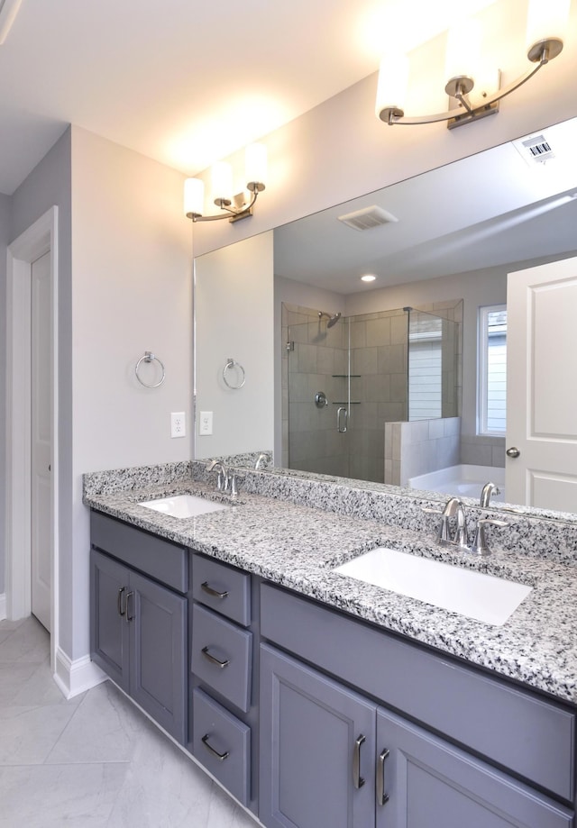 bathroom featuring a shower with shower door and vanity