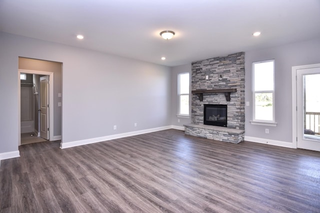 unfurnished living room with a fireplace and dark hardwood / wood-style floors