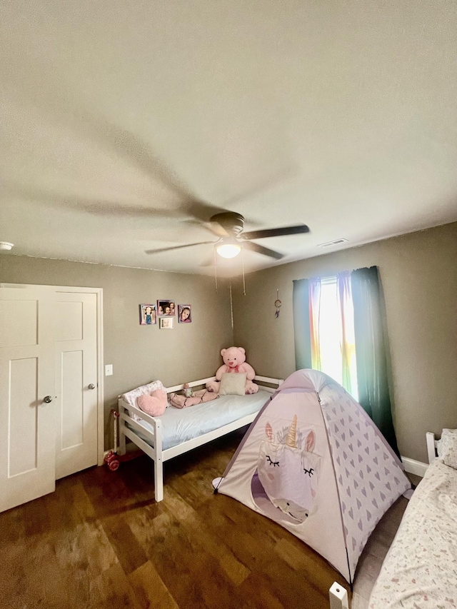 bedroom featuring dark wood-type flooring and ceiling fan