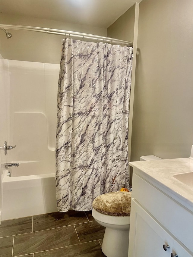 full bathroom featuring toilet, vanity, and shower / tub combo with curtain