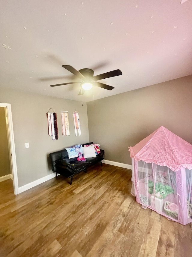 interior space with ceiling fan and hardwood / wood-style flooring