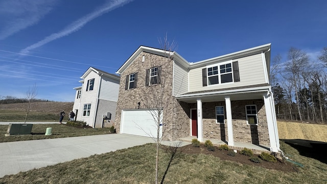 view of front facade with a garage, a porch, and a front lawn