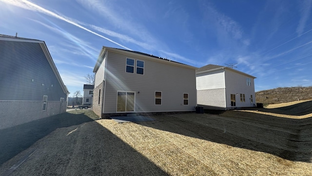 rear view of property with cooling unit