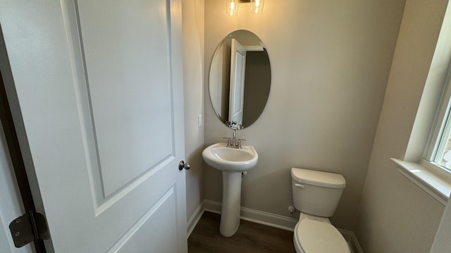 bathroom featuring hardwood / wood-style floors and toilet