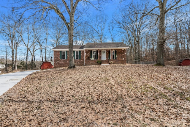 ranch-style house with a storage shed