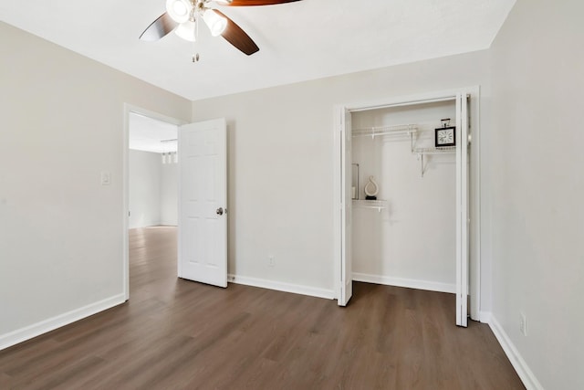 unfurnished bedroom with ceiling fan, dark wood-type flooring, and a closet