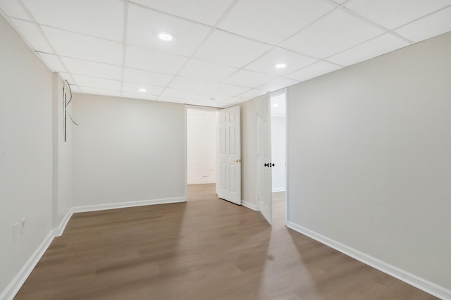 empty room featuring a drop ceiling and wood-type flooring