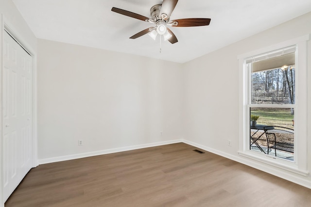 empty room with wood-type flooring and ceiling fan