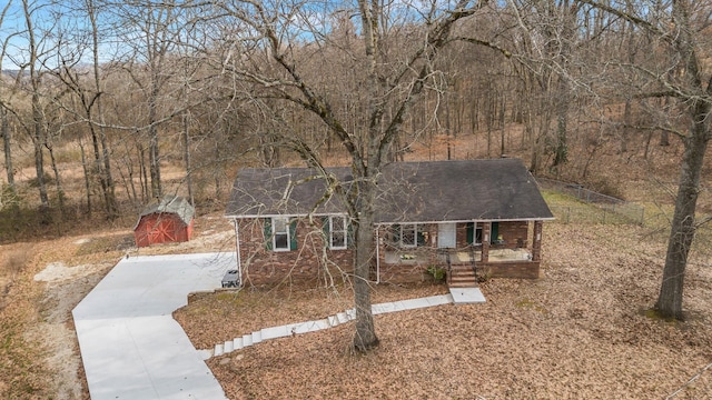 view of front of property with covered porch and a storage unit