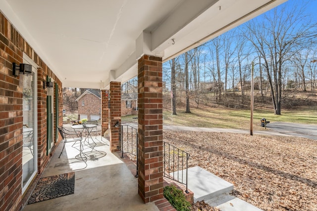 view of patio / terrace featuring covered porch and a garage