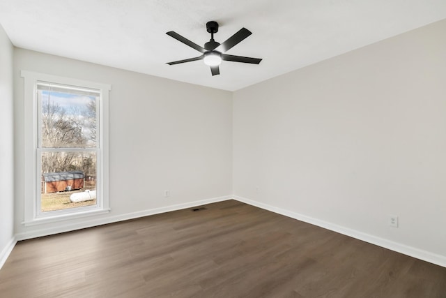 unfurnished room with ceiling fan and dark hardwood / wood-style floors