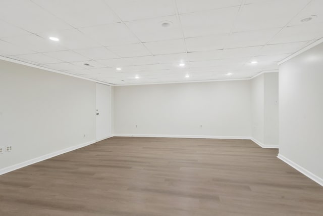 spare room with wood-type flooring and ornamental molding