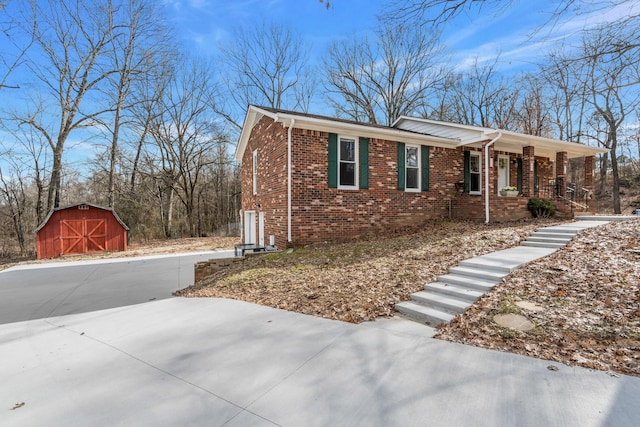 view of front of property with a porch and a storage shed