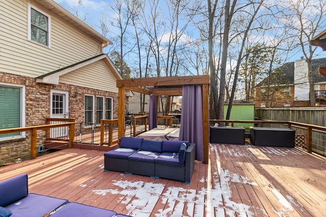 wooden deck featuring a storage shed and outdoor lounge area