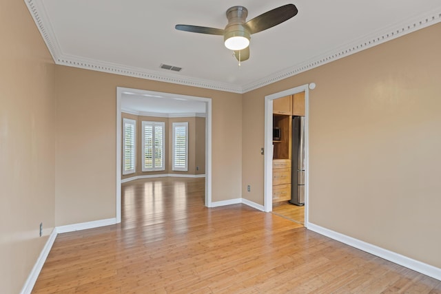 empty room featuring ornamental molding, ceiling fan, and light hardwood / wood-style flooring