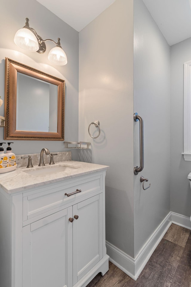 bathroom with hardwood / wood-style floors and vanity