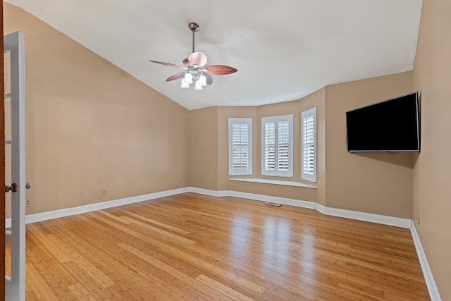 unfurnished living room with ceiling fan, vaulted ceiling, and light hardwood / wood-style floors