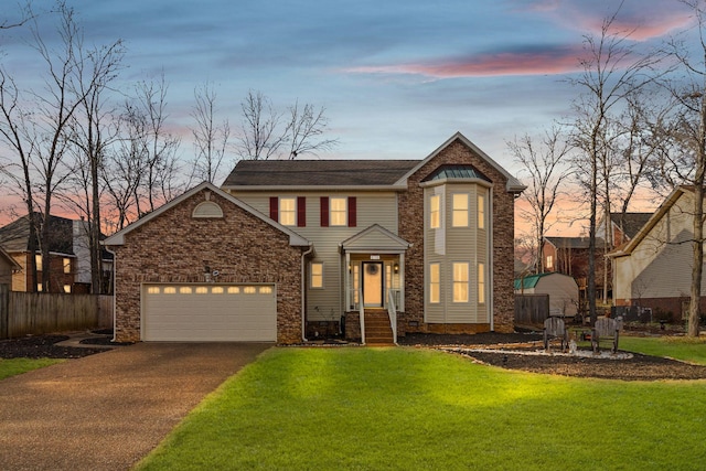 view of front facade with a garage and a yard