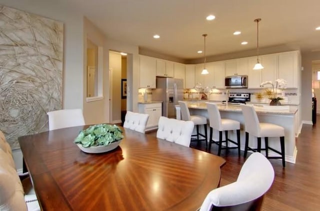 dining area with dark hardwood / wood-style flooring