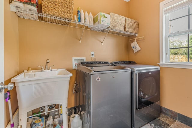 washroom featuring washer and dryer and sink