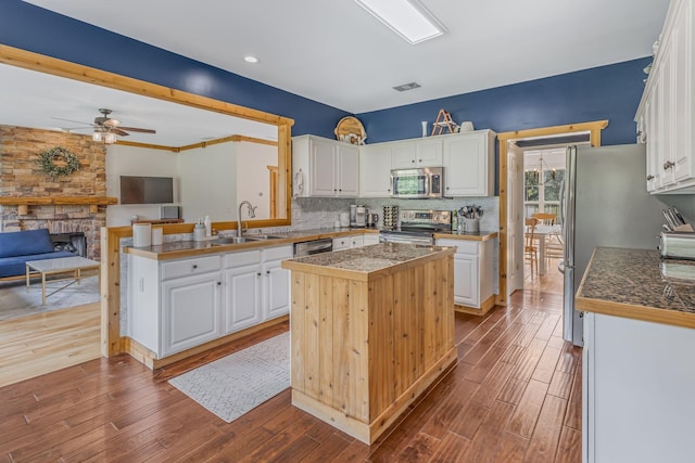 kitchen with sink, white cabinetry, a center island, and stainless steel appliances