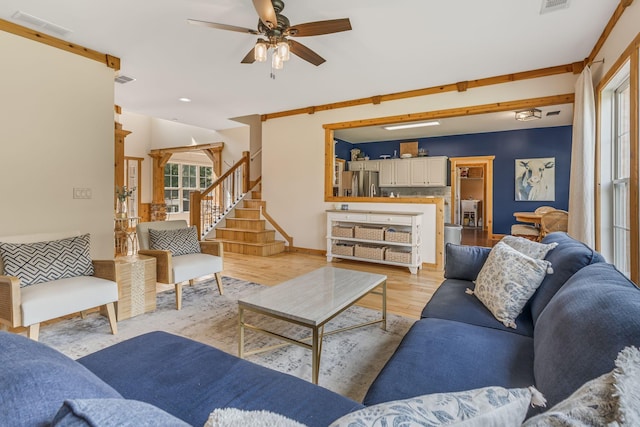 living room featuring light hardwood / wood-style floors and ceiling fan