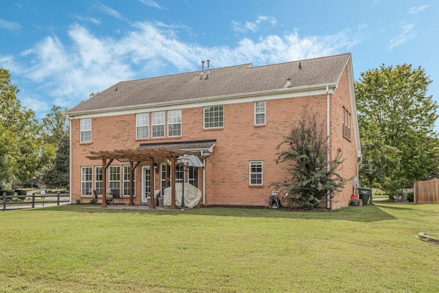 back of property featuring a patio area, a yard, and a pergola