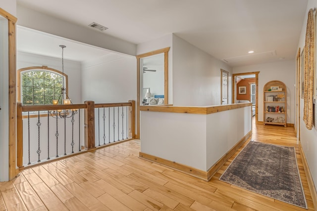 corridor with light hardwood / wood-style floors