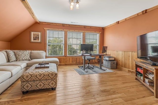 office space with vaulted ceiling and light wood-type flooring