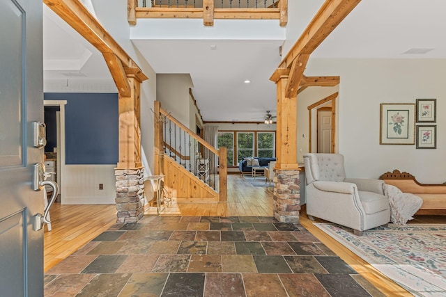 entrance foyer featuring ceiling fan and beam ceiling