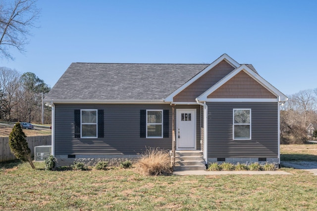 view of front of home with a front lawn and central AC unit