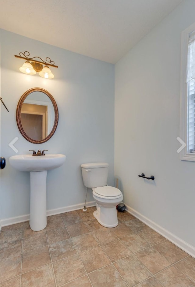 bathroom featuring toilet and plenty of natural light