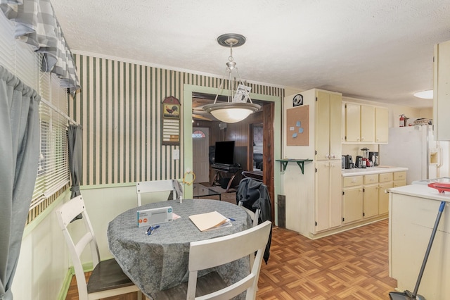 dining area with light parquet flooring and a textured ceiling