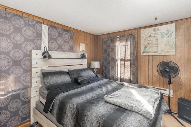 carpeted bedroom featuring a baseboard radiator and wooden walls