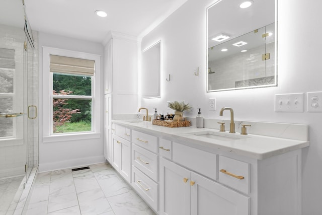 bathroom featuring a sink, baseboards, marble finish floor, and a shower stall