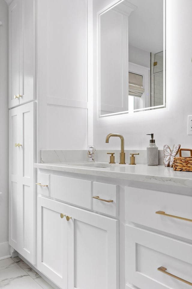 bathroom featuring marble finish floor and vanity