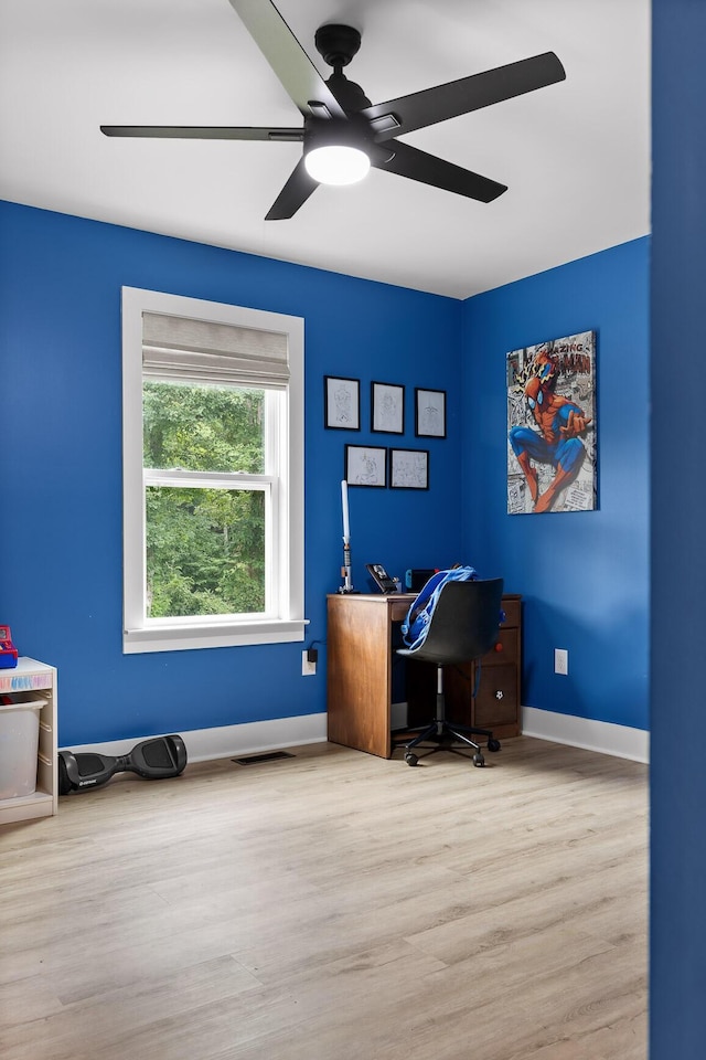 office area featuring visible vents, baseboards, wood finished floors, and a ceiling fan