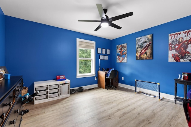 interior space with a ceiling fan, wood finished floors, and baseboards